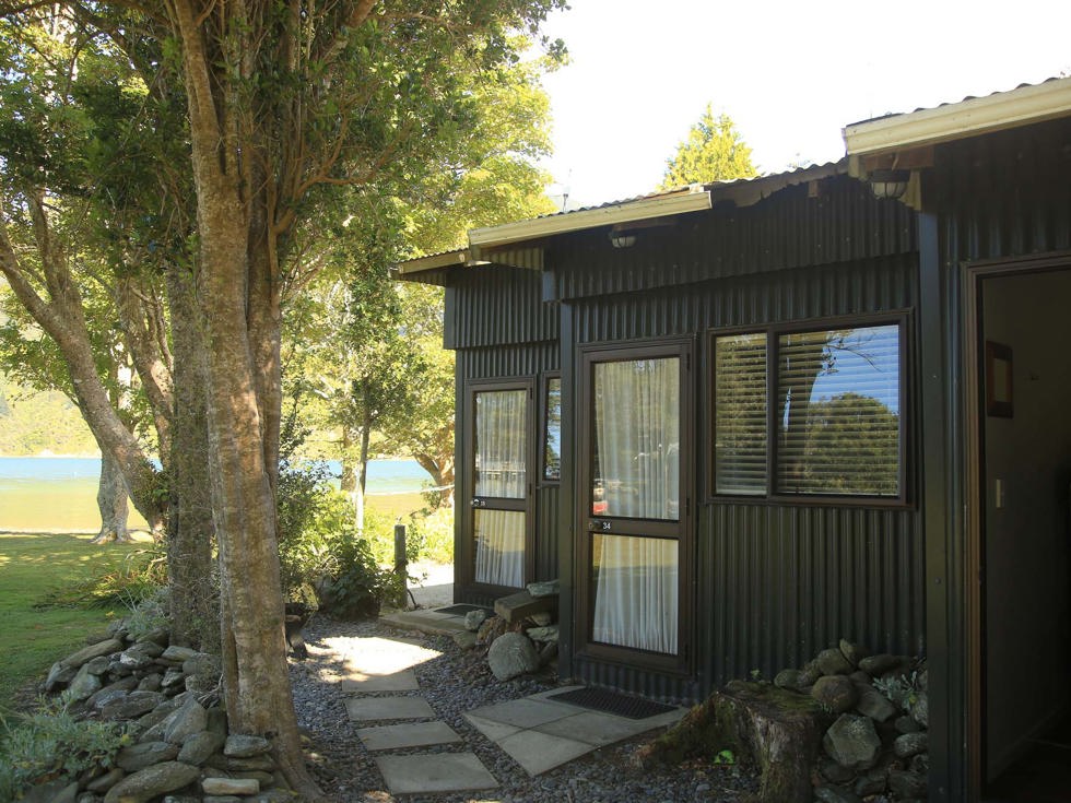 Three Hiker's Cabins surrounded by trees at Furneaux Lodge in the Marlborough Sounds at the top of New Zealand's South Island.