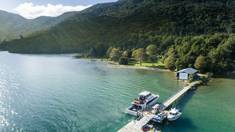 Furneaux Lodge jetty is in the foreground and Furneaux Lodge jetty in the background, in the Marlborough Sounds at the top of New Zealand's South Island.