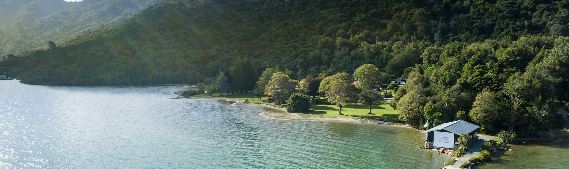 Furneaux Lodge jetty is in the foreground and Furneaux Lodge jetty in the background, in the Marlborough Sounds at the top of New Zealand's South Island.