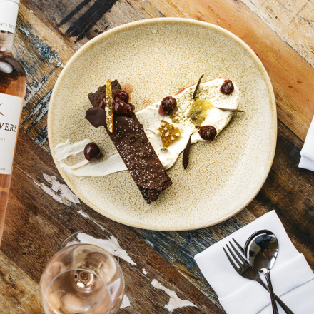 Delicious house-made brownie with cream served with a glass of Two River's Rose at the Furneaux Lodge Restaurant in the Marlborough Sounds at the top of New Zealand's South Island.