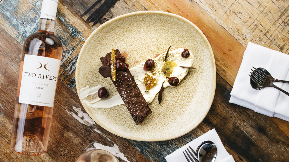 Delicious house-made brownie with cream served with a glass of Two River's Rose at the Furneaux Lodge Restaurant in the Marlborough Sounds at the top of New Zealand's South Island.