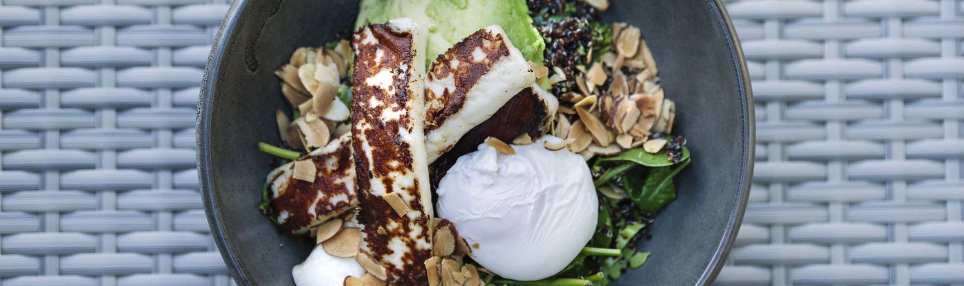 A breakfast bowl with avocado, haloumi and spinach, with egg at the Furneaux Lodge Restaurant in the Marlborough Sounds at the top of New Zealand's South Island