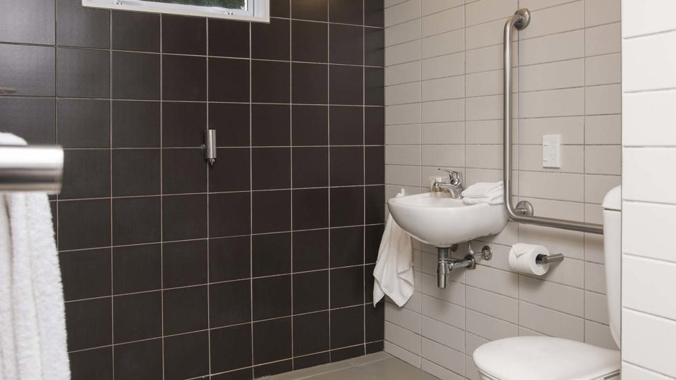 A Tobias Junior Suite ensuite bathroom with shower and toilet at Furneaux Lodge in the Marlborough Sounds at the top of New Zealand's South Island.