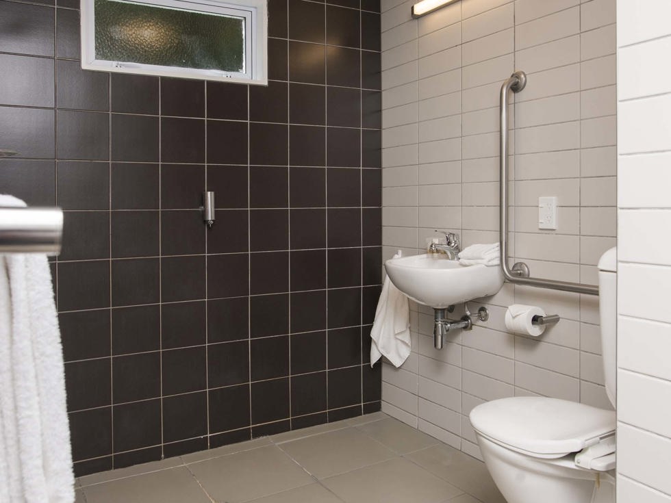 A Tobias Junior Suite ensuite bathroom with shower and toilet at Furneaux Lodge in the Marlborough Sounds at the top of New Zealand's South Island.