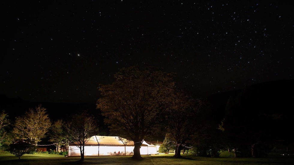 A marque is set up on the Furneaux Lodge lawn for the evening wedding reception in the Marlborough Sounds in New Zealand's top of the South Island