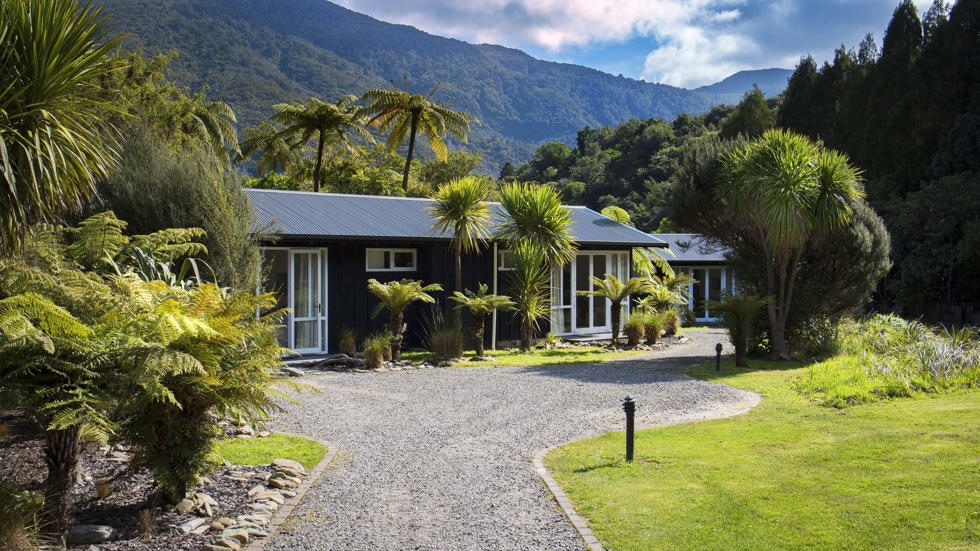 Endeavour Suites are surrounded by lush green forest and native bush at Furneaux Lodge in the Marlborough Sounds at the top of New Zealand's South Island.