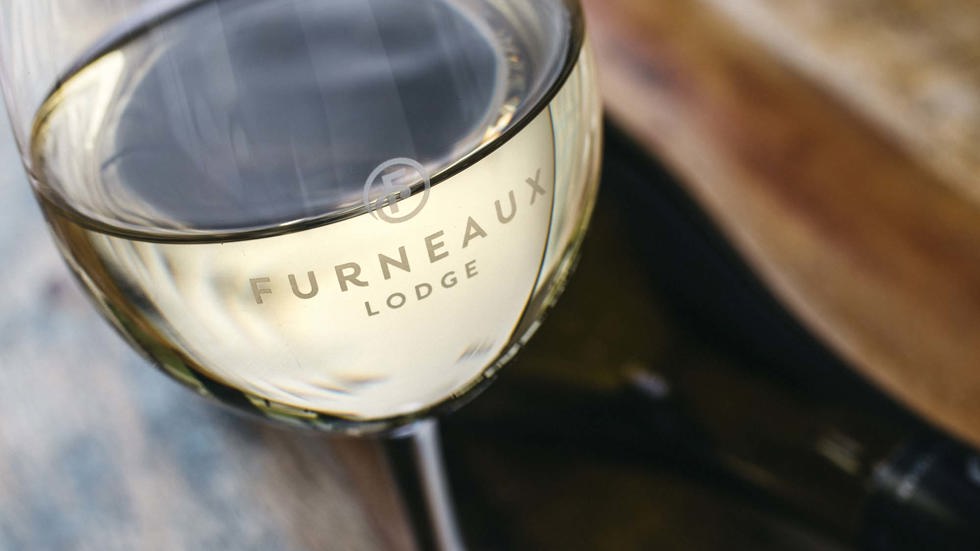 Marlborough Sauvignon Blanc in a Furneaux Lodge wine glass at the Furneaux Lodge Restaurant in the Marlborough Sounds at the top of New Zealand's South Island