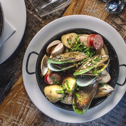 A bowl of freshly steamed mussel as a sharing plate option at the Furneaux Lodge Restaurant in the Marlborough Sounds at the top of New Zealand's South Island.