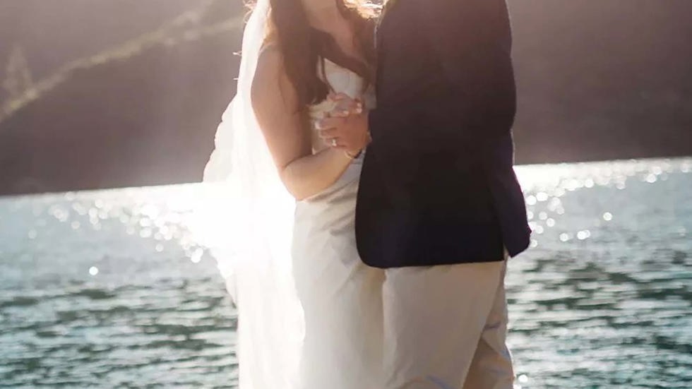 A bride and groom dance with each other on the Furneaux Lodge jetty in the Marlborough Sounds in New Zealand's top of the South Island